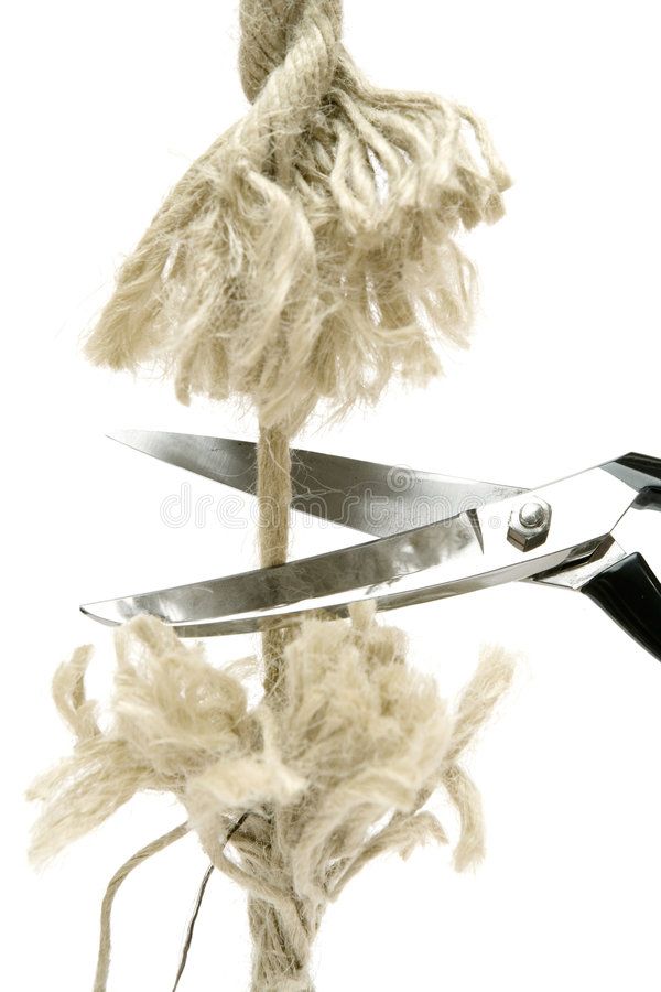 closeup of a pair of scissors cutting through a length of rope. the scissors are open and the blades are resting on the rope. the rope is made of natural fibers and is frayed at the edges. the background is white.