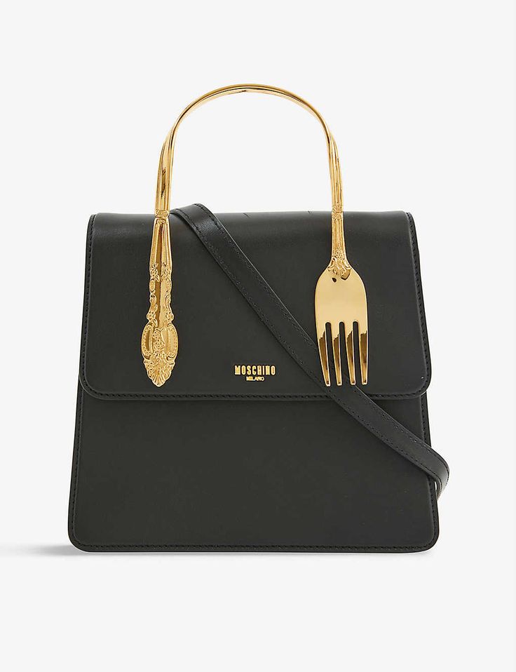 a black moschino handbag with a gold fork handle and a shoulder strap.