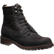 the image shows a pair of men's brown leather boots with a laceup closure. the boots have a rugged look and appear to be made of highquality leather. they feature a thick sole and a padded collar for comfort.
