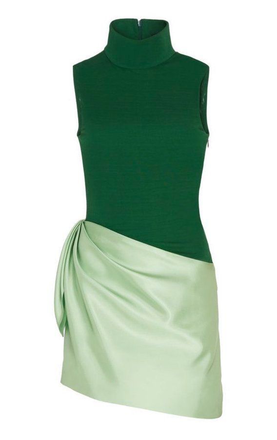 a sleeveless dress with a turtleneck collar, featuring a green knit top and an asymmetrical, draped skirt in a lighter, satinlike fabric.