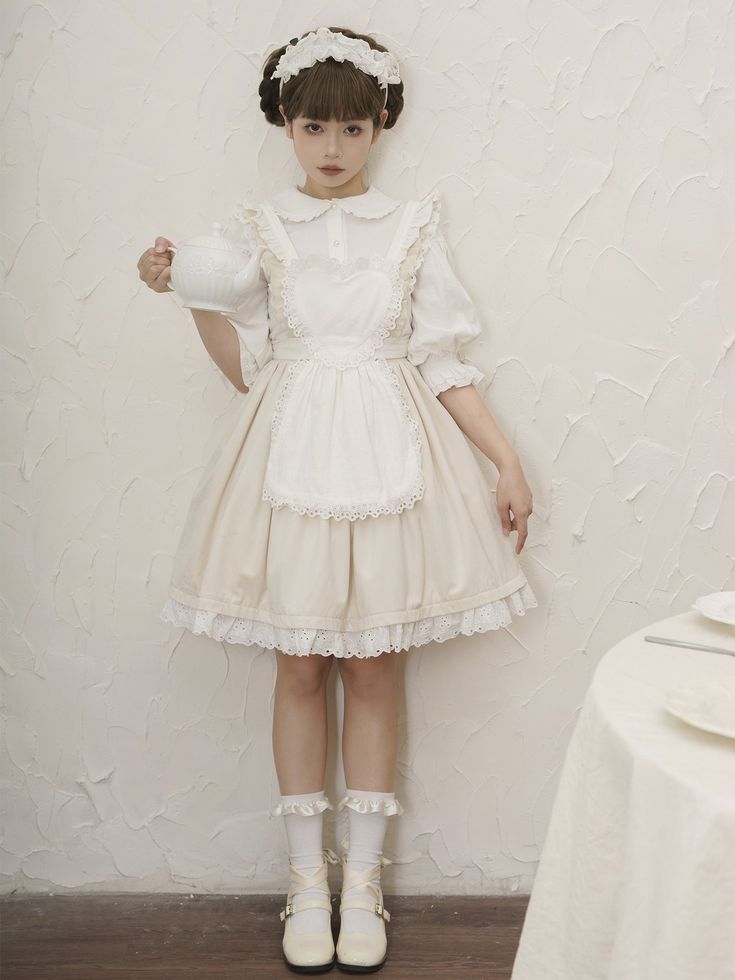 a young woman, dressed in a classic lolitastyle maid dress, stands in a softly lit indoor setting. the dress, predominantly white and beige, features intricate lace detailing on the apron and hem. she holds a white teacup gracefully in her hand, further enhancing the elegant and feminine aesthetic.  the overall mood evokes a sense of delicate charm and sophistication, reminiscent of a whimsical tea party.