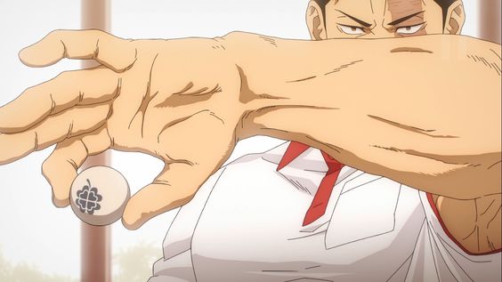 a closeup image of an anime man holding a small, round, white object with a clover symbol on it. he is wearing a white and red shirt. the lighting is soft and the overall tone of the image is warm.