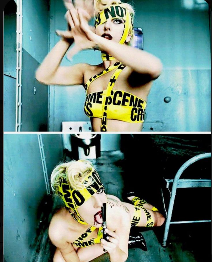 the image is a still from lady gaga's music video for "paparazzi."  it's a diptych, showing two shots of lady gaga in a seemingly derelict bathroom setting. she is partially nude and adorned with yellow crime scene tape that's fashioned into a top and a blindfold.  in the bottom image, she's on the ground, holding a gun and blood is visible around her mouth.  the overall aesthetic is dark, provocative, and reflects the themes of the music video. the color palette is dominated by blues and yellows from the tape.