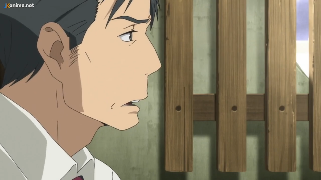 a closeup side view of an adult man with short, dark hair and a concerned expression. he appears to be outside in the daytime, with a weathered wooden structure visible behind him. the lighting is soft and natural, creating a sense of unease and contemplation.