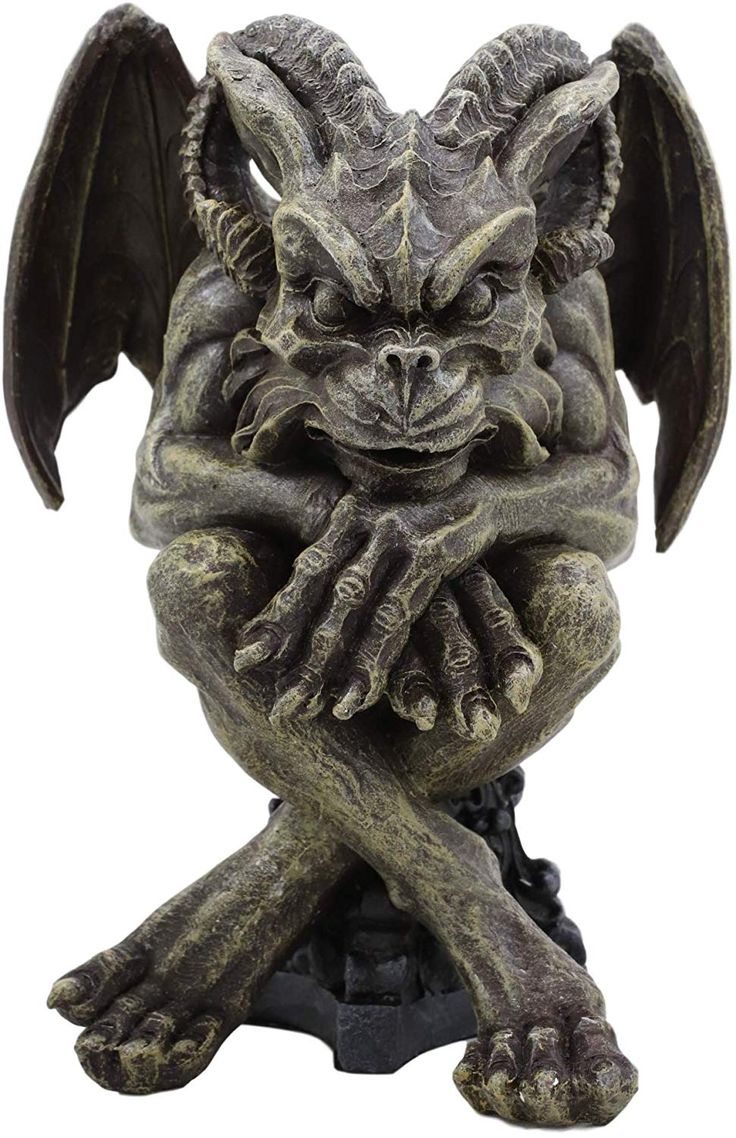 the image shows a gray stone gargoyle statue with wings and horns, perched on a dark base. it has a gothic, demonic appearance, resembling a mythological creature. its hands are crossed over its chest, and its legs are crossed at the ankles. the statue is highly detailed and textured.