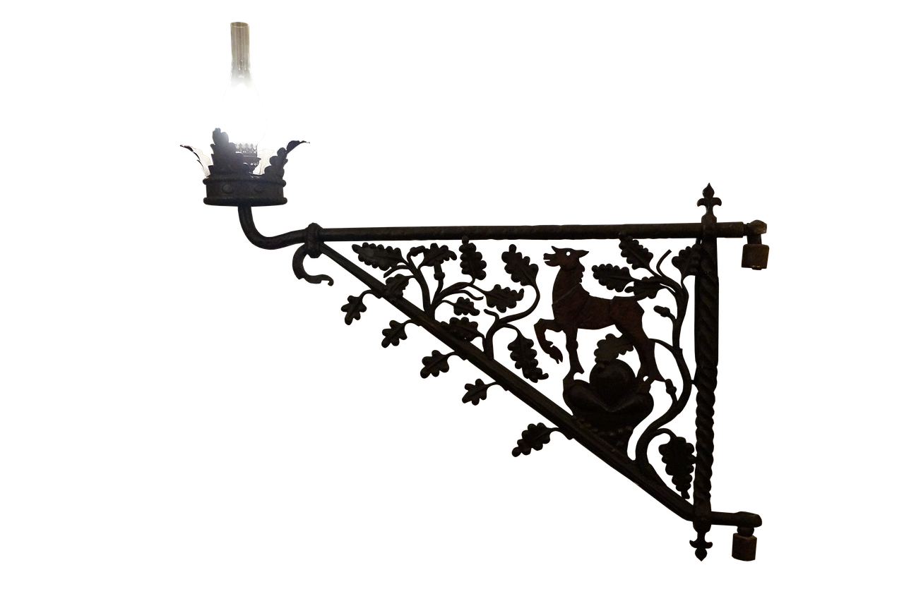 an ornate wrought iron light fixture with a deer and leaf design is mounted against a black background. the lamp at the end of the fixture is lit.