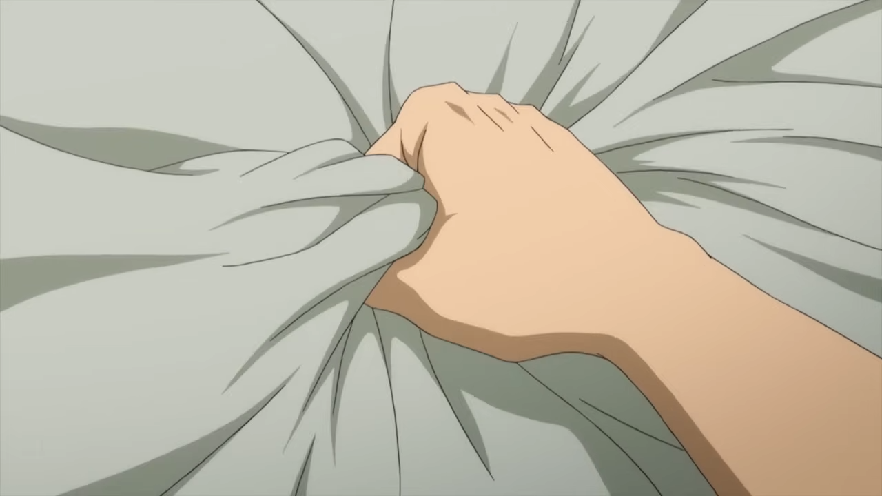an image of a hand gripping onto a blanket. the hand is clenched into a fist and the knuckles have turned white.