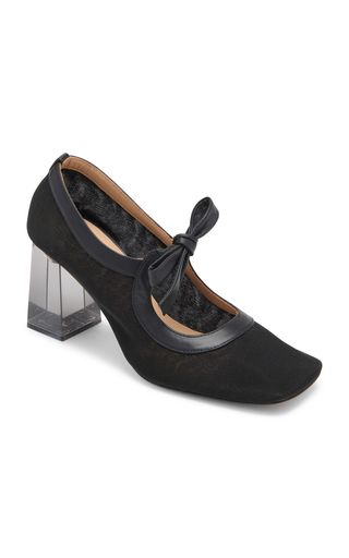 a black, squaretoed highheeled pump with a bow embellishment. the heel is clear acrylic. the shoe is elegant and stylish.