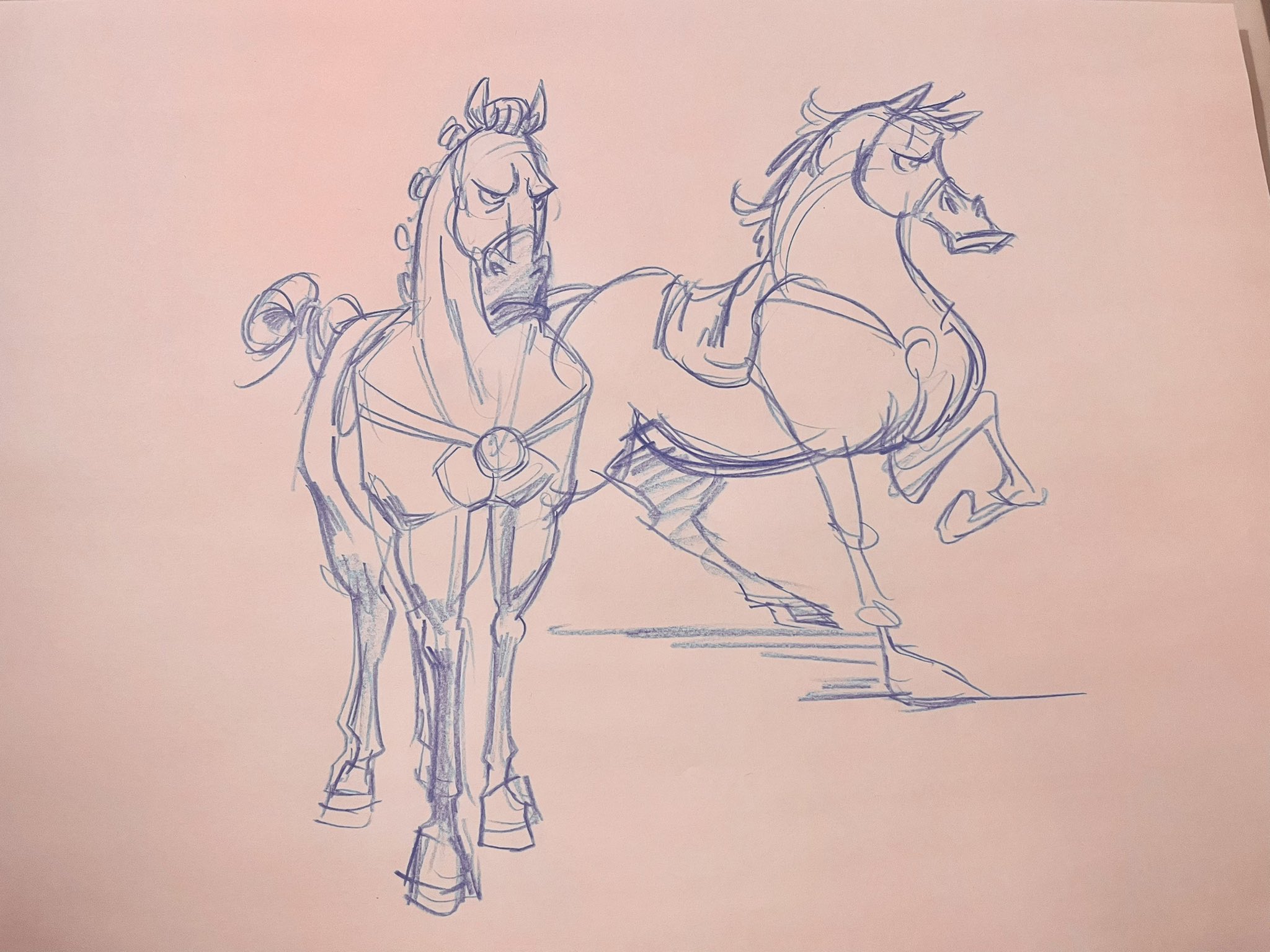 this is a sketch of what appears to be concept art for an animated film or show. the sketch shows two horses, one partially obscuring the other. the horse on the left is standing in place while the horse on the right is in motion. both horses have exaggerated features, such as large heads and thin legs, and appear to have expressive faces. the sketch is drawn in blue pencil on a pink piece of paper.