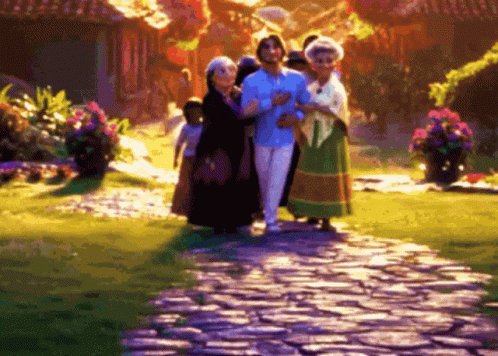 image is a still from disney's animated movie, "encanto." it shows three people walking along a stone path through a lush garden. bruno madrigal is in the center, flanked by two older women, presumably alma madrigal. there is a child partially visible on the left side of the group. the scene is brightly colored with vibrant flowers and greenery.