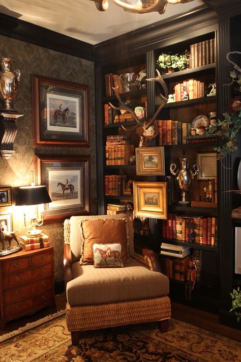 the image showcases a cozy and opulent home office or library. it features a plush armchair nestled in a corner, flanked by a builtin bookcase overflowing with books, decorative items, and equestrianthemed art. the rich, dark wood of the bookcase and furnishings, coupled with the dim lighting and warmtoned accessories, creates an inviting and sophisticated ambiance.