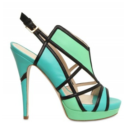the image shows a pair of women's highheeled sandals. the shoes are a turquoise and mint green color with black leather accents creating a geometric pattern.  they have a slingback design and a platform heel. the style is modern and fashionable.