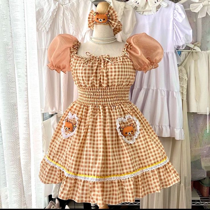 a yellow and white gingham lolita dress with bear detail on the bust and skirt. the dress has puffed sleeves and ruffles.