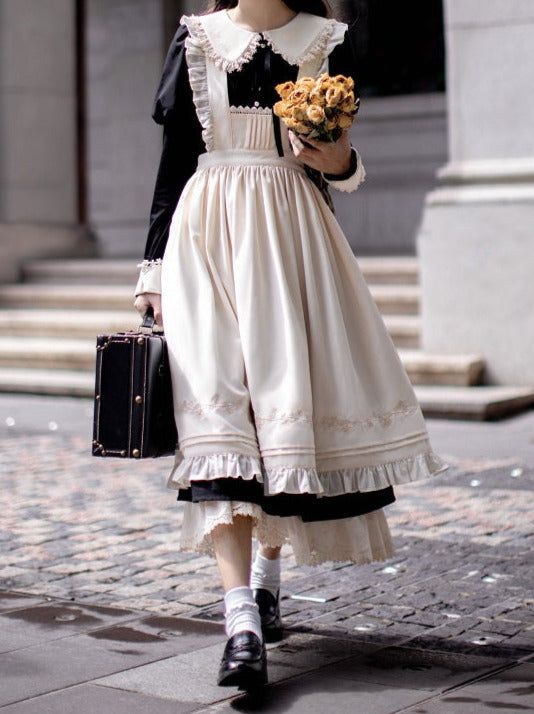a woman wearing a vintageinspired lolita fashion outfit is walking down a city street. she is carrying a black suitcase and a bouquet of yellow flowers. the outfit is a creamcolored dress with black accents and ruffles, paired with a black top and white socks and shoes. the photo is taken from an eyelevel perspective, with natural, overcast lighting.