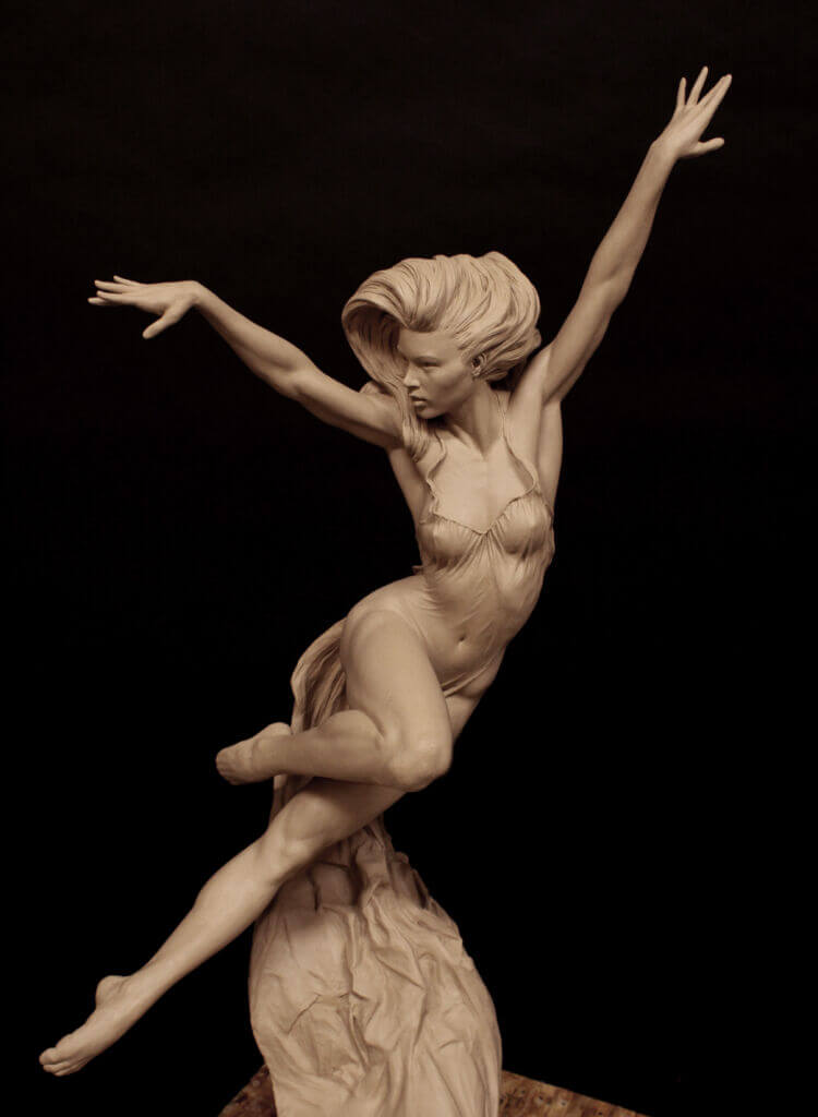 a clay sculpture of a woman caught in middance. the figure is sculpted in a dynamic pose, with her arms outstretched and one leg lifted, conveying a sense of lightness and grace. the sculpture is set against a dark background, emphasizing the form and texture of the clay.  the lighting is dramatic, highlighting the curves and contours of the figure.