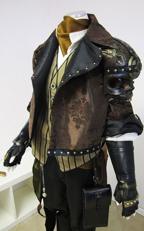 a steampunk costume is displayed on a mannequin. the costume consists of a brown jacket with ornate damask detailing and black trim, a striped vest, black pants, black gloves with metallic accents, and a small black bag hanging from the waist. the right shoulder features elaborate, masklike steampunk armor. the overall style of the costume is elaborate, and detailed, characteristic of the steampunk aesthetic.