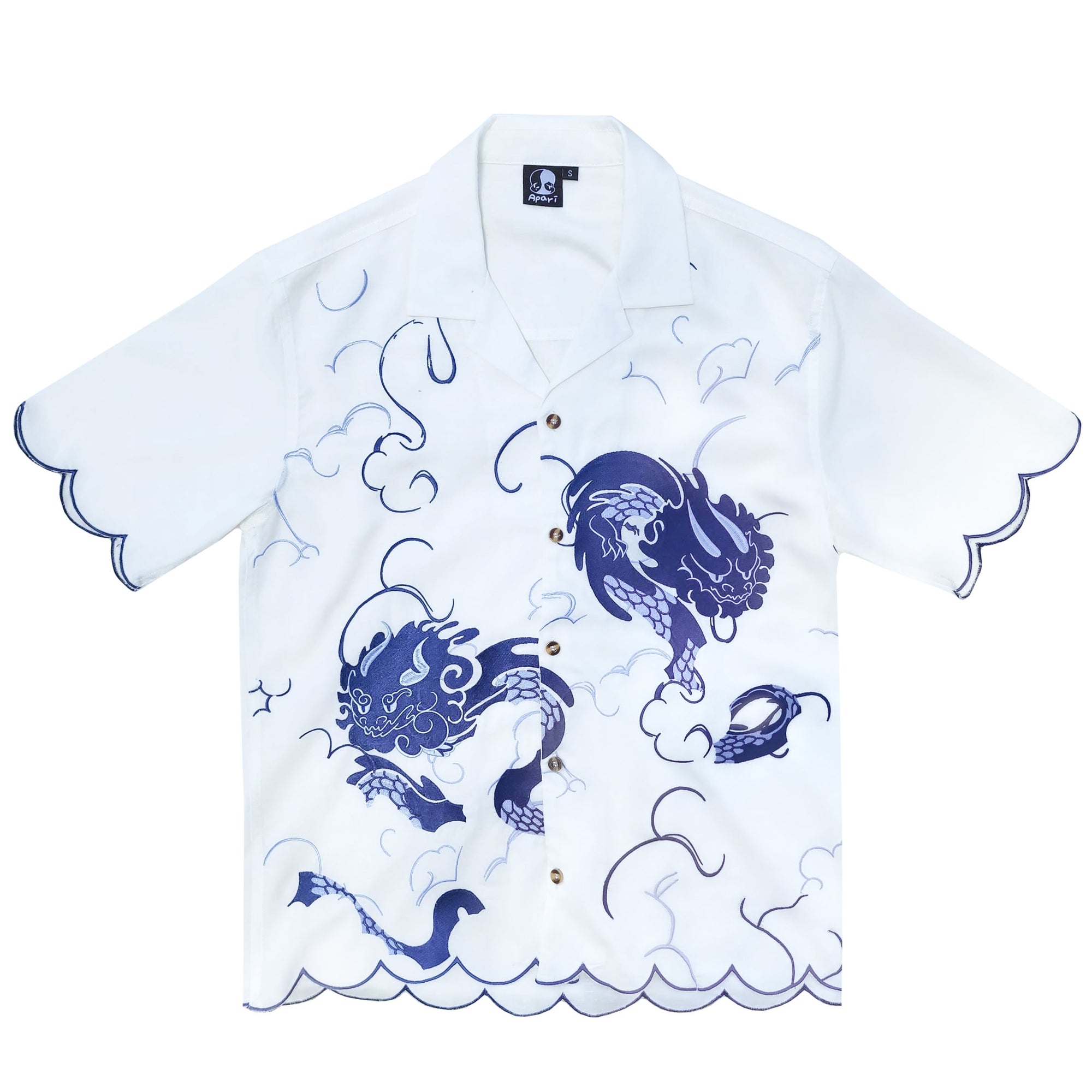 a white shortsleeve shirt with a blue dragon pattern is displayed. the shirt has a scalloped edge on the sleeves and bottom. the shirt has a collar.