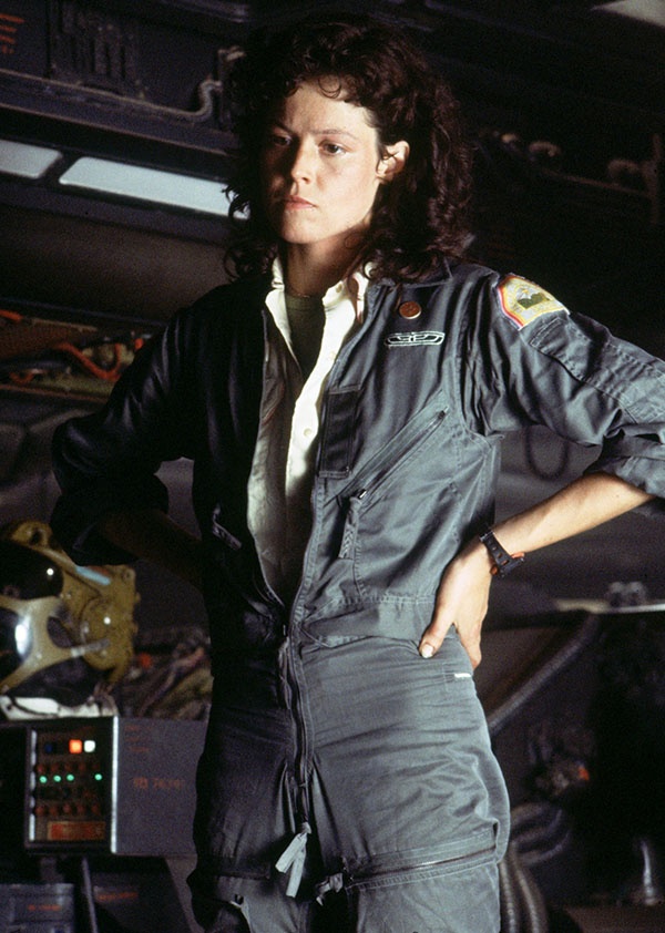 a still image of sigourney weaver as ellen ripley, wearing her iconic jumpsuit, in the film alien (1979). the image was likely taken on the set of the film.