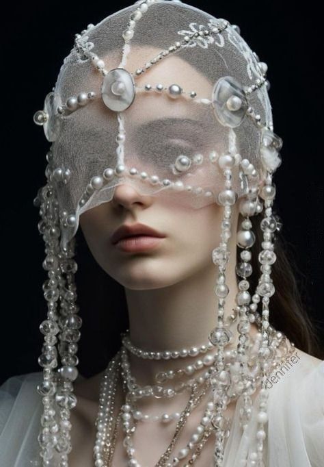 a closeup portrait of a woman wearing an elaborate pearl and veil headdress. she is adorned with multiple pearl necklaces. the headdress covers her eyes with a sheer veil, and strands of pearls hang down around her face and neck.