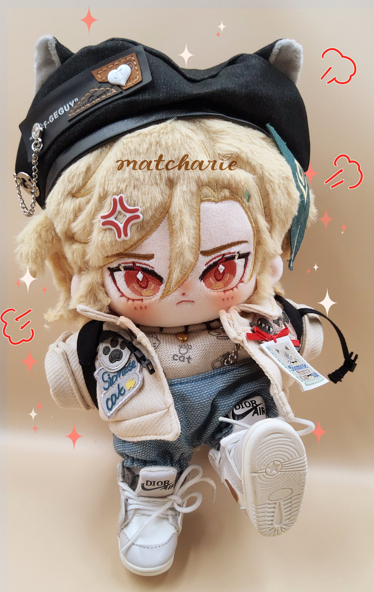 this image shows a plush doll wearing a white jacket, jeans, sneakers, and a black hat. the doll also has blonde hair and is wearing a casual outfit. the doll's eyes are closed and it looks like it is smiling.  the doll has a cute and cheerful appearance.  the doll is sitting on a beige background and there are some hearts and stars drawn around it.  the doll is very well made and detailed.  it would make a great gift for any child or collector.