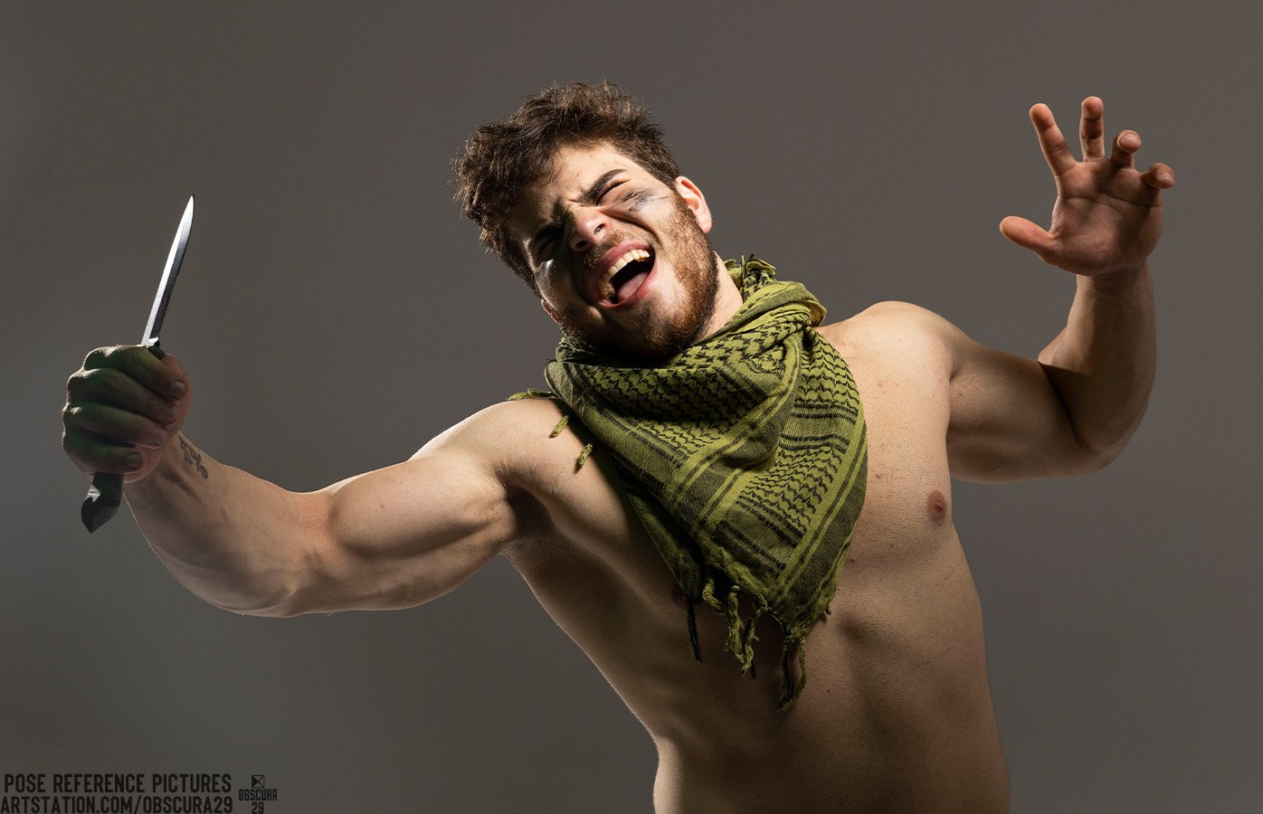 a shirtless man in a keffiyeh with a knife in his hand is posed as if he is fighting. he has a serious expression on his face and is yelling.  he has a strong and muscular body. the background is plain grey and he is the only subject in the image.