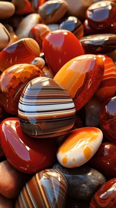 a closeup shot of a variety of agates, with vibrant colors and patterns. the stones are polished, revealing their smooth, shiny surfaces and intricate details.