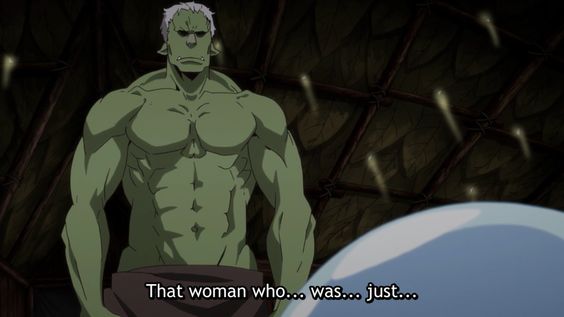 a muscular, green skinned, humanoid character with white hair is looking at the viewer with an angry expression. it is standing in front of a dark, textured background with shadows and glowing lights. the background is dark and mysterious. the character is standing in the foreground with the dark background behind it.  the character has a small cloth draped around its waist. it appears to be wearing nothing else. the image appears to be from an animated show or movie.