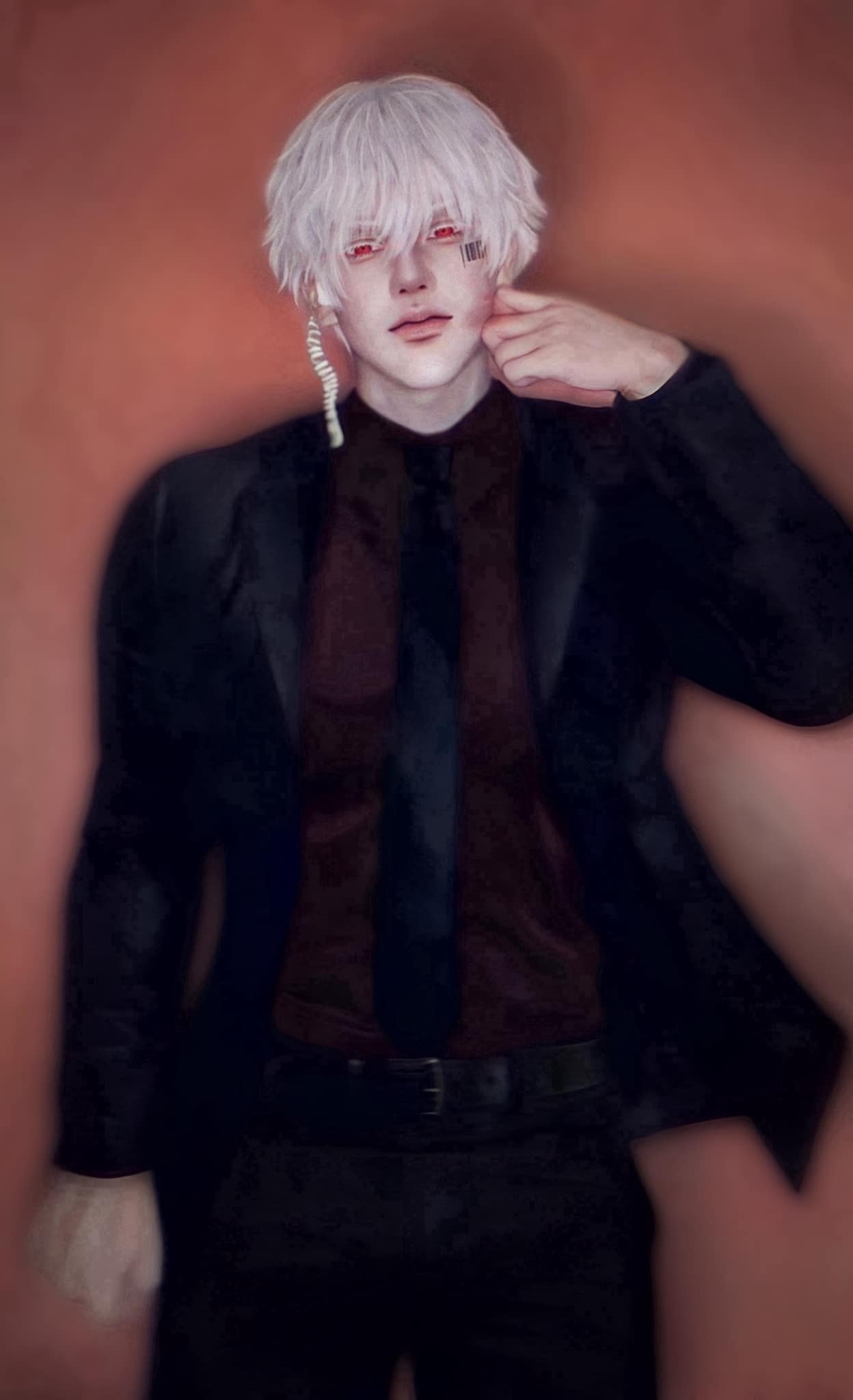 a man with white hair and red eyes dressed in a black suit and a tie, looks at the camera with a serious expression. he's standing in a studio setting.