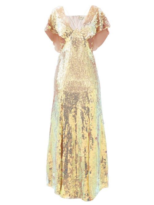 a stunning gold sequin dress with a vneckline and cutout details on the back. the dress is floorlength and features a flowing skirt, perfect for a special occasion. the sequins shimmer and sparkle, adding a touch of glamour to the look.