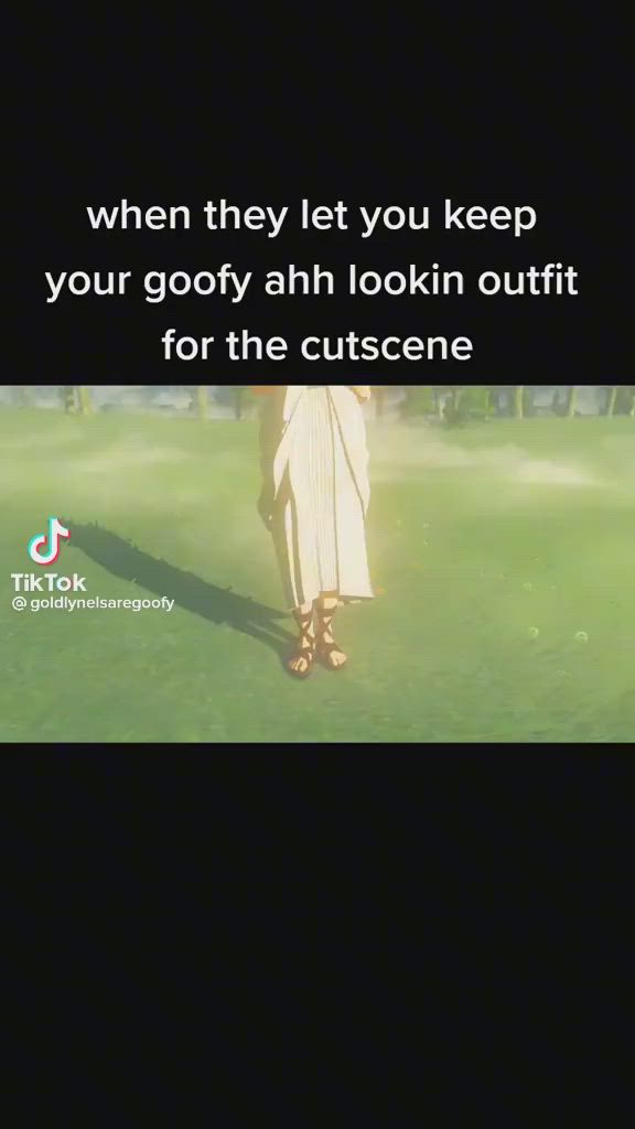 a still from a tiktok video about video game cutscenes. the video is from the account @goldlynelsaregoofy, and the caption reads, "when they let you keep your goofy ahh lookin outfit for the cutscene." the video shows an animated character,  wearing a long white robe and sandals, walking through a green grassy area, likely in a video game. the caption is a humorous take on video game cutscenes, often where players are forced to wear certain outfits or costumes during the cutscene.