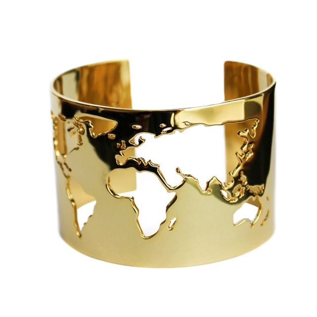 a gold cuff bracelet with a world map cutout design. it is a minimalist and stylish accessory that is perfect for any occasion. the bracelet is made of highquality materials and is sure to last for years to come. the map cutout design is a unique and eyecatching detail that adds a touch of sophistication to any outfit. the bracelet is also a great conversation starter and is sure to get you noticed.