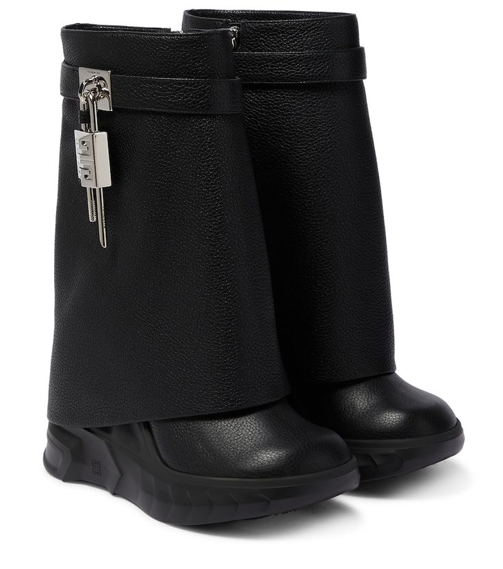 a pair of black leather women's boots with a foldover design and a chunky wedge heel. the boots feature a zipper closure, buckle detail, and a textured leather upper.