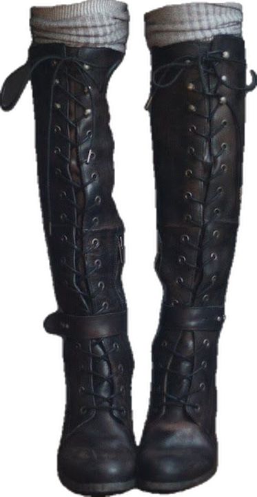 a pair of black leather thighhigh boots with laceup detail and side zippers are shown. the boots are worn with gray socks that peek out from the top. the boots have a chunky heel. they appear to be made of highquality leather and have a slightly distressed or worn look.  the style is reminiscent of gothic or punk fashion.