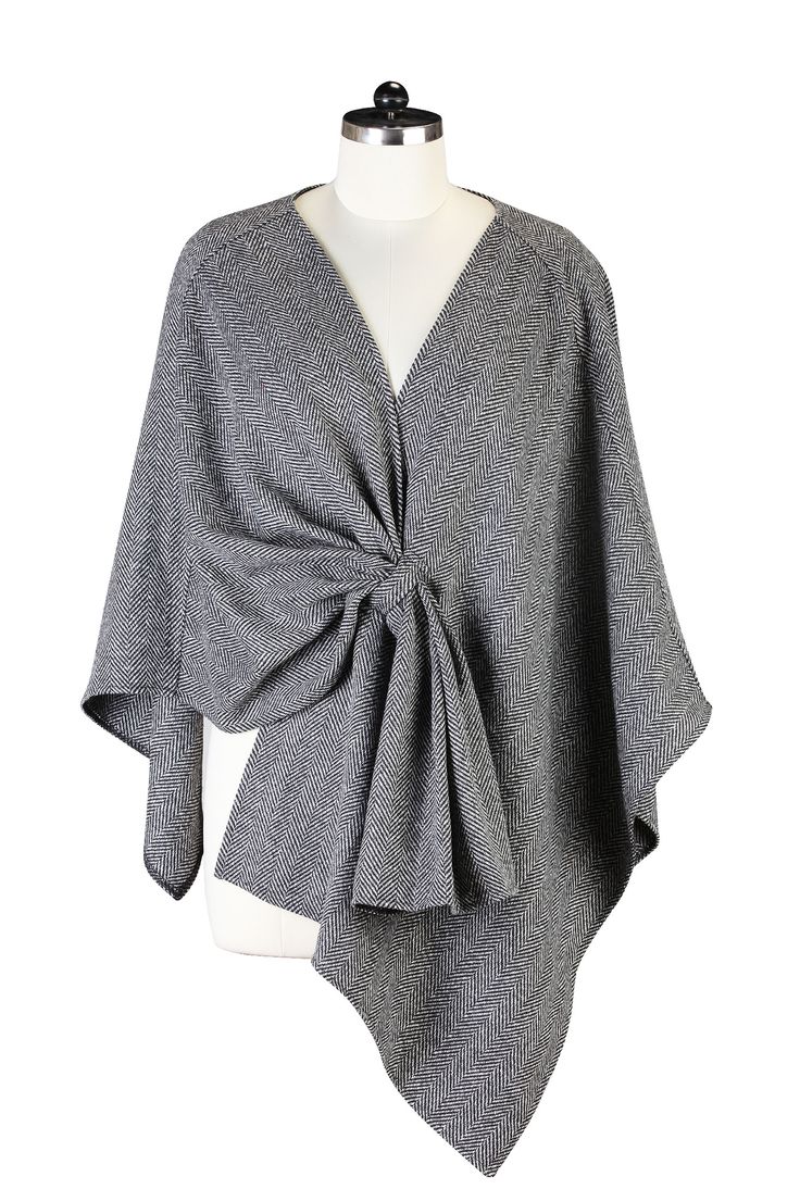 a gray herringbone cape is tied in a knot at the front of a mannequin.