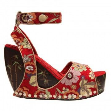 a single red floral print wedge sandal with a dark brown heel and platform bottom is centered in the frame. the sandal has an ankle strap with a round beige button. the heel and platform bottom feature a bamboo print. the sole has white beads along the edge.