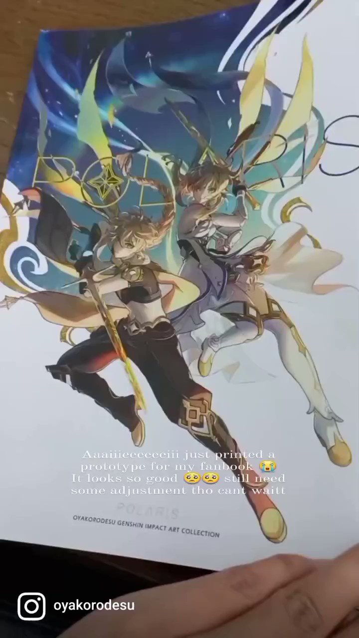 a person is holding a printed prototype for their genshin impact fanbook. the image is a close up of the prototype, which features two characters from the game, ganyu and raiden shogun. the characters are drawn in a colorful and detailed style. the person wrote "anamecececin just printed a prototype for my fanbook. it looks so good, still need some adjustment tho, can't wait!" the text "gyakorodesu genshin impact art collection" and "polaris" are also written on the prototype. the hand in the foreground is blurry and holding the prototype, but the background is a desk.