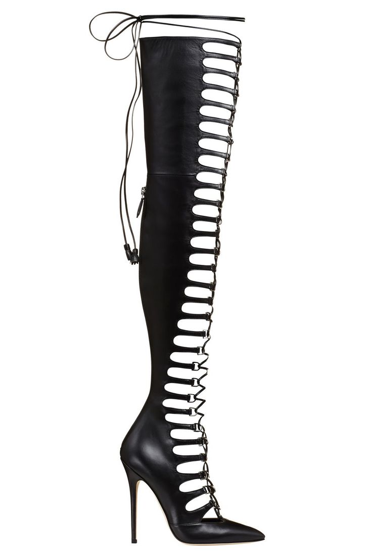 a pair of black leather women's high heel boots. the boots have an open toe and are cut out with several straps and buckles.  the heels are stiletto style and are very high.