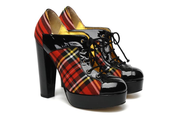 a pair of platform high heels with a plaid pattern and black patent leather detailing. the shoes have laces and high block heels.
