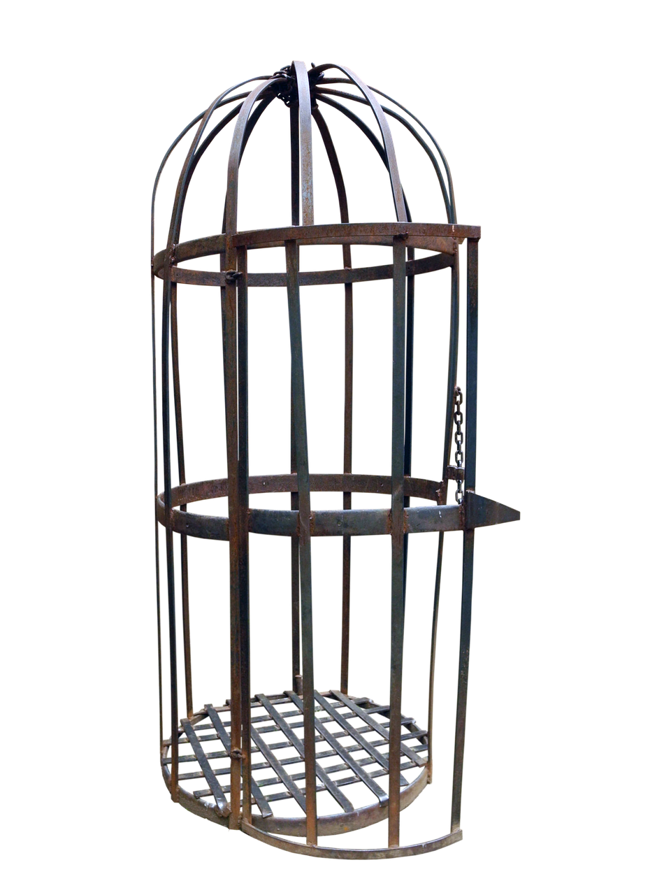 the image shows a rusty, antique iron cage or birdcage against a black background. the cage features a cylindrical shape with a domed top made of metal bars. it has horizontal bands around the middle and a gridded floor. a small door with a chain is visible on one side, suggesting it could be opened and closed. the object appears to be a historical piece, possibly used as a torture device or for confinement in a prison or dungeon.