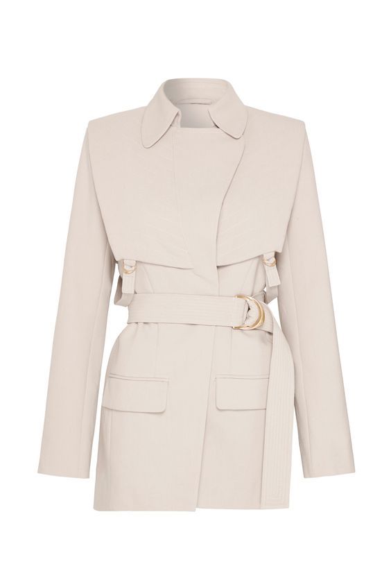 a cream colored, belted blazer jacket is displayed against a white background. the blazer is fitted with a long sleeve and features a classic lapel, and two front squareshaped pockets. a matching beige belt with a golden dshaped buckle is clasped around the blazer, and buckles are attached near the lapel.
