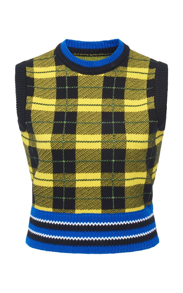 closeup view of a sleeveless yellow and black plaid knit sweater vest.  the vest has a crew neck, a blue trim at the neck and bottom hem, and features a bold plaid pattern. the bottom hem also has a band of blue, white and black stripes. the texture of the knit is visible. the image is taken against a white background.