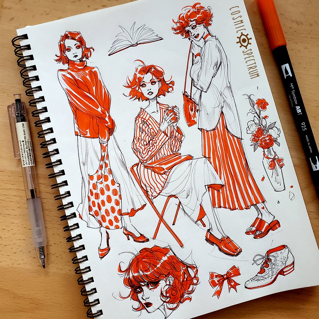 the image shows a sketchbook page filled with fashion illustrations.  the style is loose and expressive, using primarily orange ink to render several female figures in various stylish outfits. the outfits feature stripes, polka dots, and are predominantly orange and white.  there are also smaller details drawn including a book, a vase of flowers, and shoes. the illustrations appear to be done with a fineliner pen or marker, possibly a tombow dual brush pen (abt 925 is visible), and are characteristic of quick sketches rather than meticulously detailed renderings.  the overall mood is playful and energetic. the sketchbook is spiral bound and rests on a light wooden surface. a tombow pen is visible resting beside the sketchbook. the words "cosmic spectrum" are written at the top of the page.