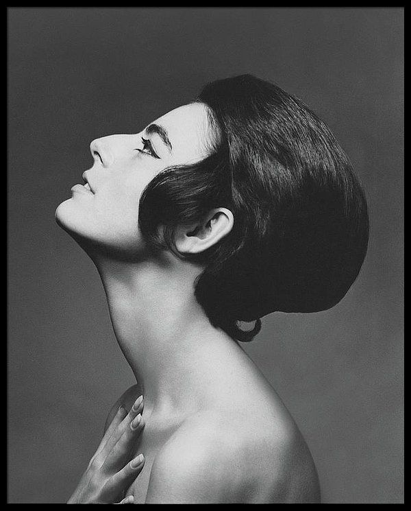 a black and white portrait of a woman in a studio setting. she is posing with her head tilted back, her eyes closed and her lips slightly parted. her hair is styled in a sleek, sophisticated manner. her skin is smooth and flawless. the photograph captures a sense of timeless elegance and beauty.