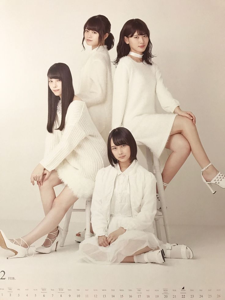 four young japanese women are sitting on a white background. they are all wearing white dresses and white shoes. they are smiling and looking at the camera. the image is a portrait of a group of young women. it is a typical fashion photograph for a jpop idol group. the image appears to be from a calendar shoot.
