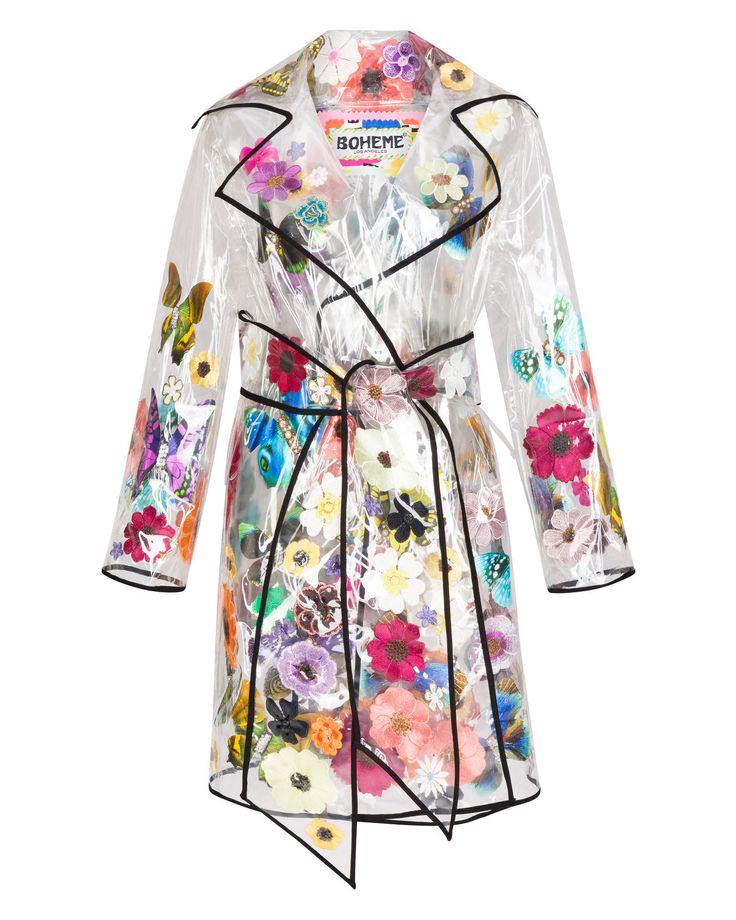 a transparent trench coat with a black trim and colorful floral pattern is displayed against a white background. the coat is tied at the waist with a matching transparent belt. the interior of the coat has an elaborate floral design. the brand name "boheme" is visible on the inside of the coat near the neckline.