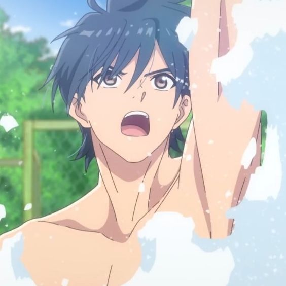 a young, shirtless anime male with dark hair is pictured outdoors with his right arm raised and a surprised look on his face. he appears to be covered in soap suds. the background consists of greenery.