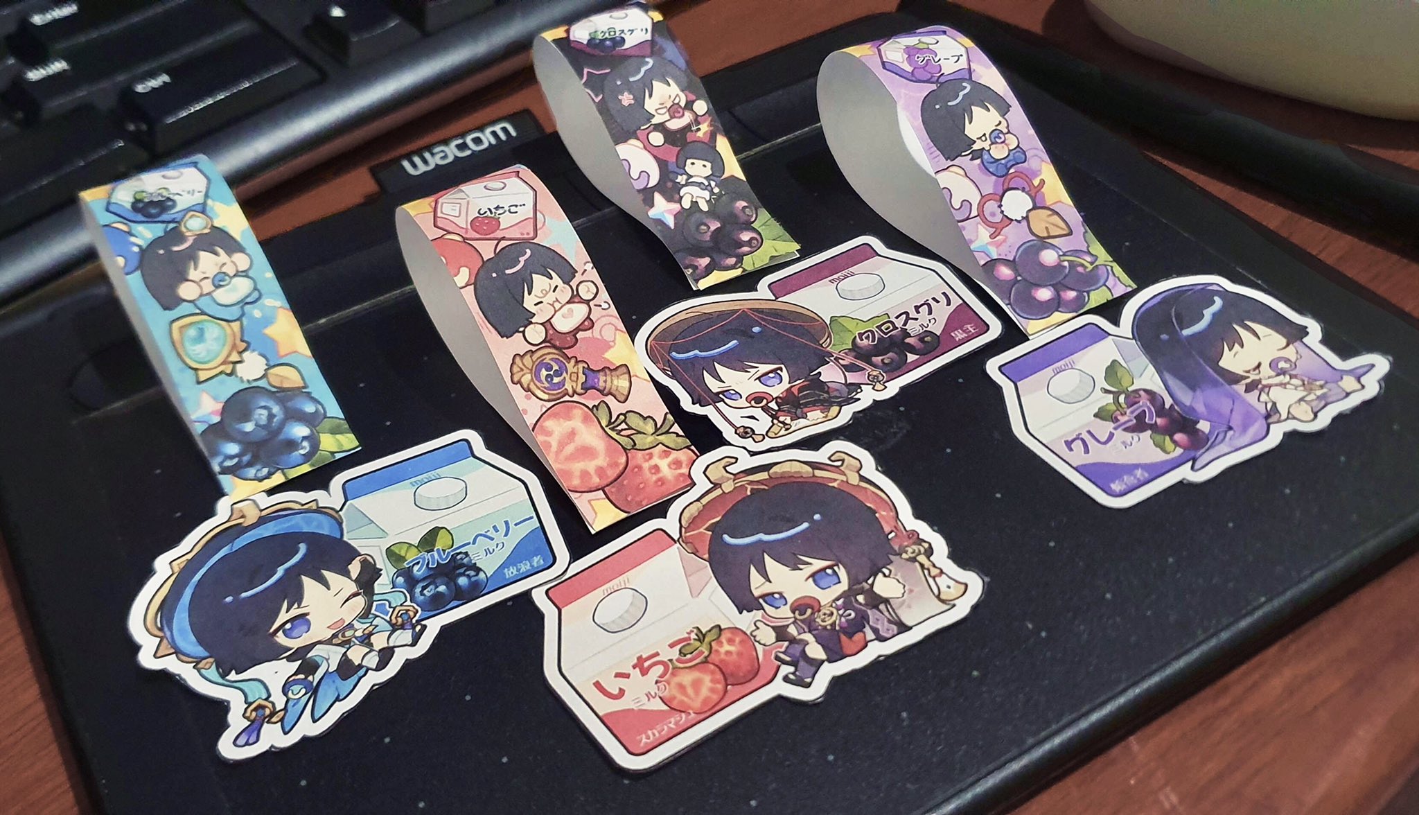 the image showcases a variety of colorful animestyle stickers featuring adorable characters enjoying milk. the stickers are designed with a milk carton theme, each displaying a different fruit flavor: strawberry, blueberry, and plum. each carton features a cute anime character, and they are all designed in a vibrant and eyecatching manner. the stickers are arranged on a dark surface, highlighting their vibrant colors and intricate details.
