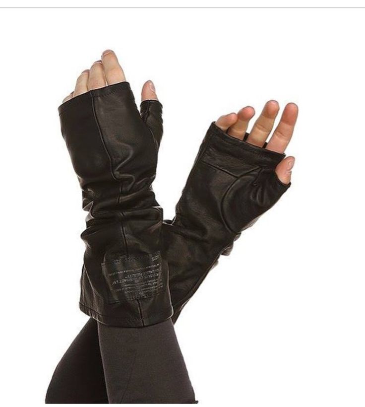 a person wearing a pair of black leather fingerless gloves with long arms. the gloves are made of a soft, supple leather and have a sleek, stylish design. the gloves are a great accessory for any occasion, whether you're dressing up for a night out or just running errands around town. they are also perfect for keeping your hands warm in the colder months.