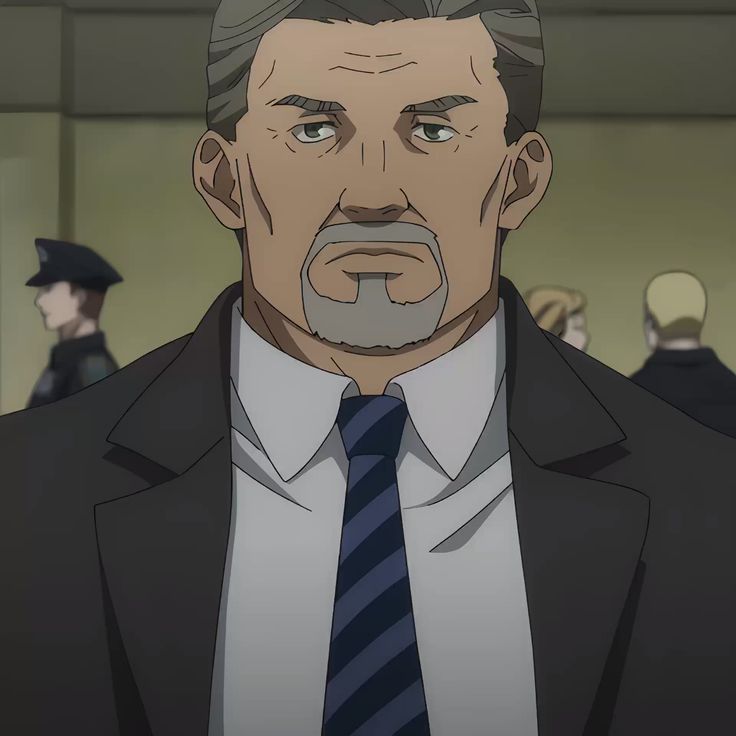 a middleaged man with short gray hair and a goatee wears a dark suit and striped blue tie. he appears serious and is the focus of the image.  in the background, blurred figures suggest a law enforcement setting, possibly a police station or courthouse.