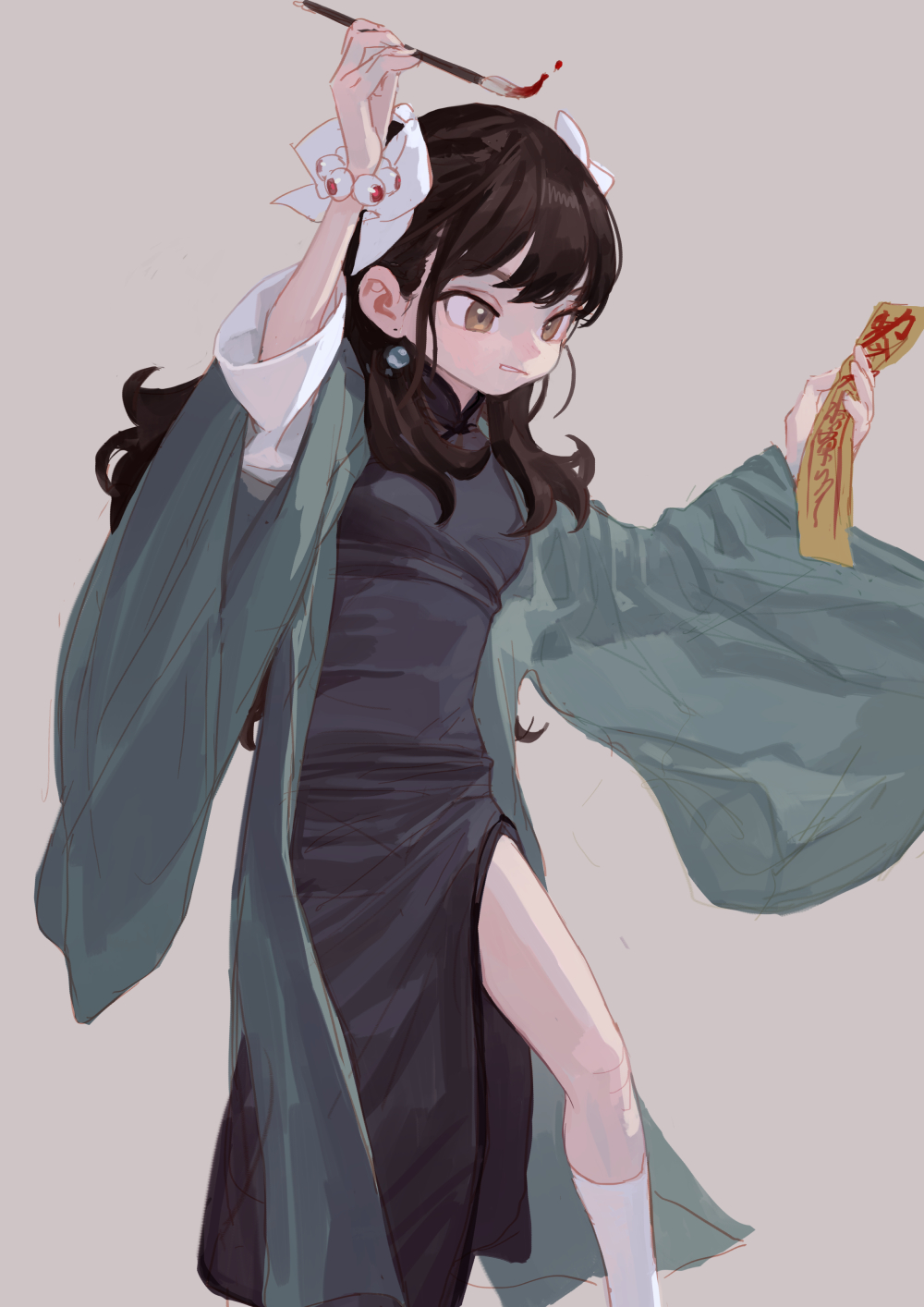 a drawing of an anime girl, she has brown hair and is wearing a short dark qipao with a high slit on the left side. over this she is wearing a green kimono, her hair is pinned back with white ribbons. in her right hand she is holding a paintbrush with blood on the end, and in her left hand she is holding a yellow talisman. she is wearing socks and earrings.